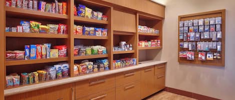 A well-organized pantry with various food items and snacks.