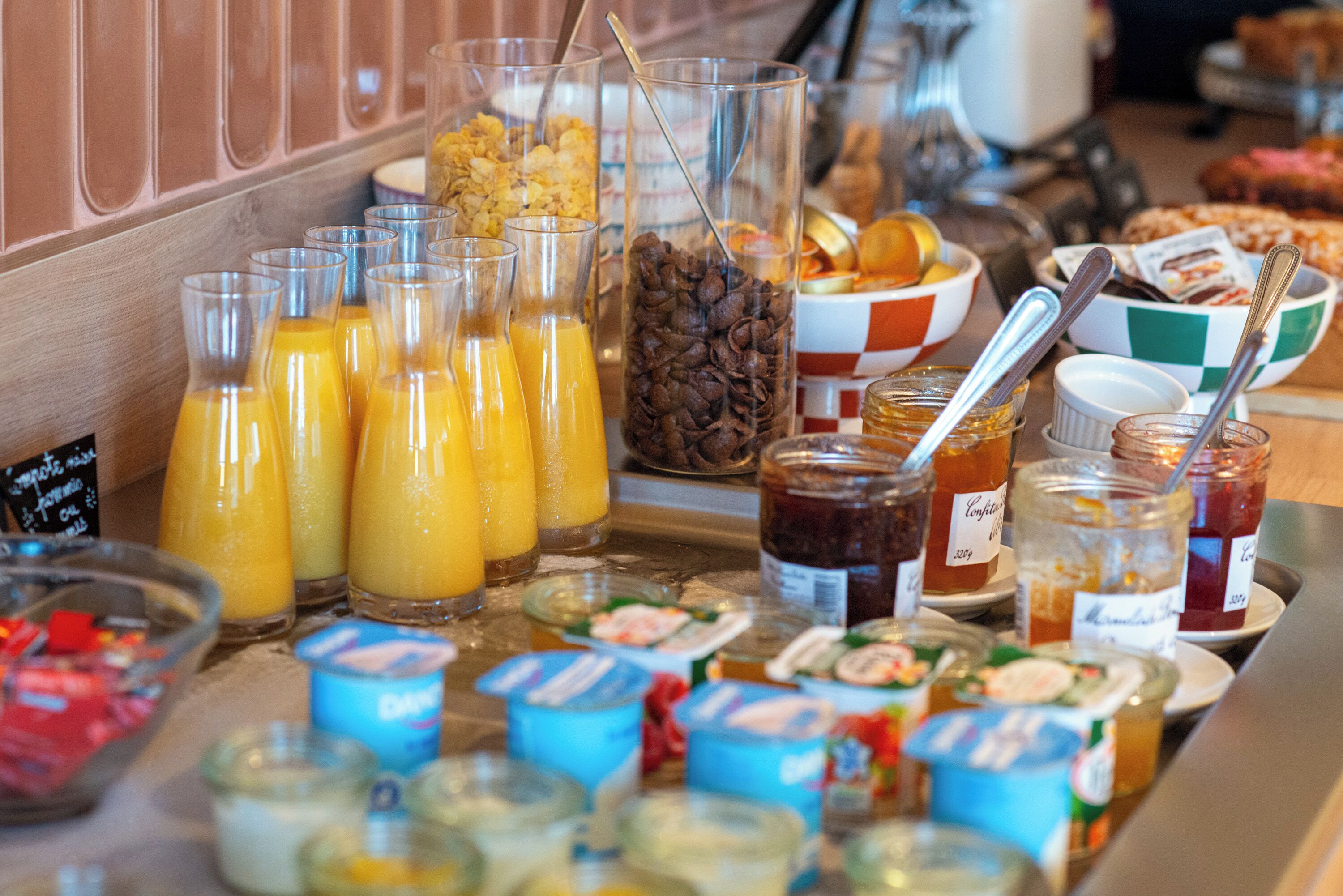 A breakfast buffet with various food items and beverages.