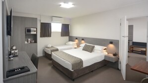 A hotel room with two beds, a desk, a TV, and a microwave. - The Bridge (Smithton)