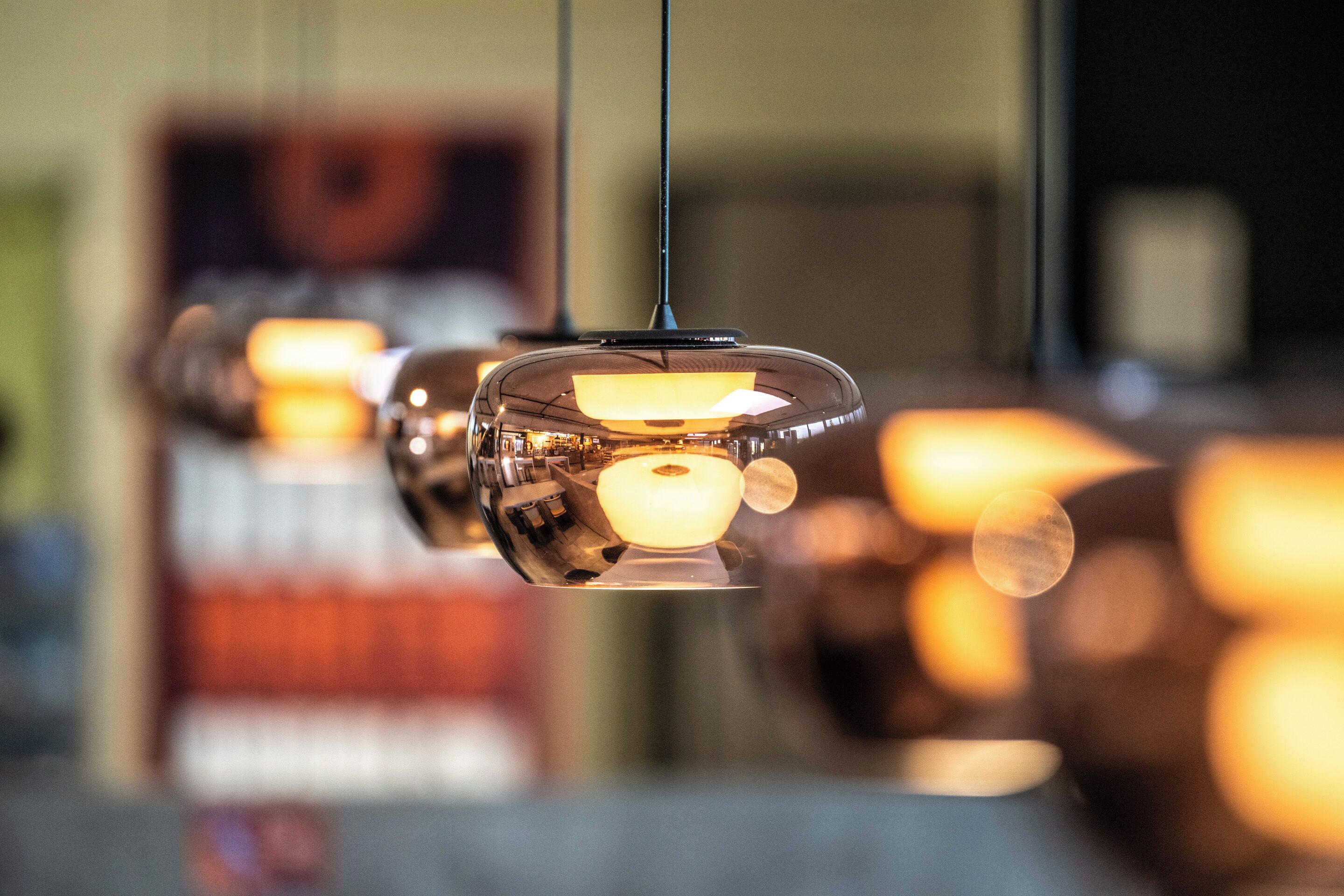 A series of hanging pendant lights with a warm glow.