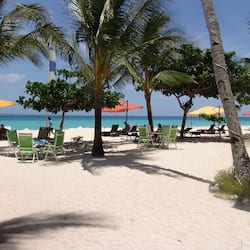 On the beach, white sand, sun-loungers, beach umbrellas