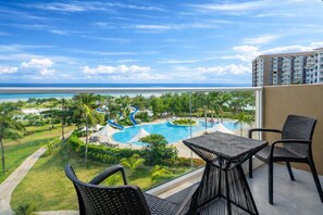 A balcony with a view of a swimming pool and ocean. - Solea Seaview Resort (Cordova)