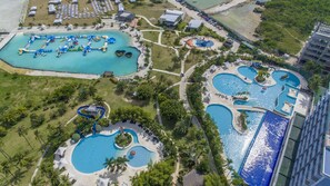 An aerial view of a resort with multiple swimming pools, a water park, and a beach area. - Solea Seaview Resort (Cordova)