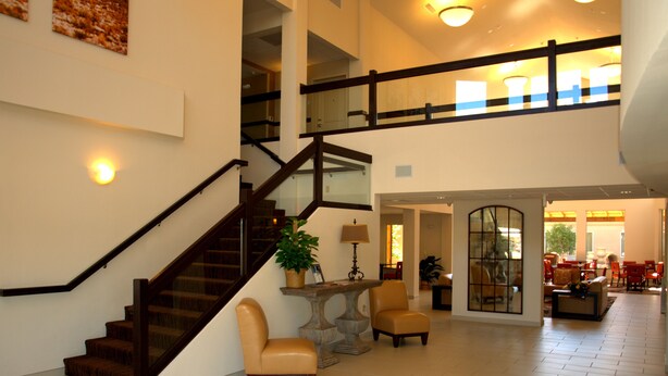 A spacious interior with a staircase, seating area, and a dining space.