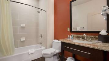 A bathroom with a bathtub, toilet, and sink.