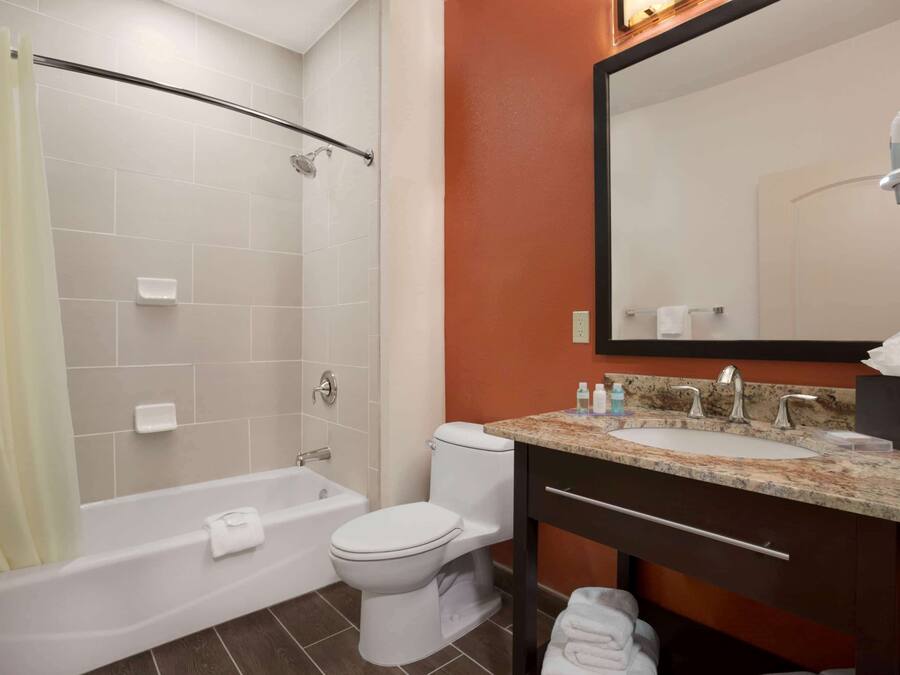 A bathroom with a bathtub, toilet, and sink.