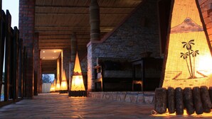 A stone-paved pathway leading to a building with a stone facade and wooden beams. - Inside Afrika Boutique Hotel (Kigali)
