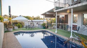 Outdoor pool, open 7:30 AM to 6:30 PM, pool umbrellas