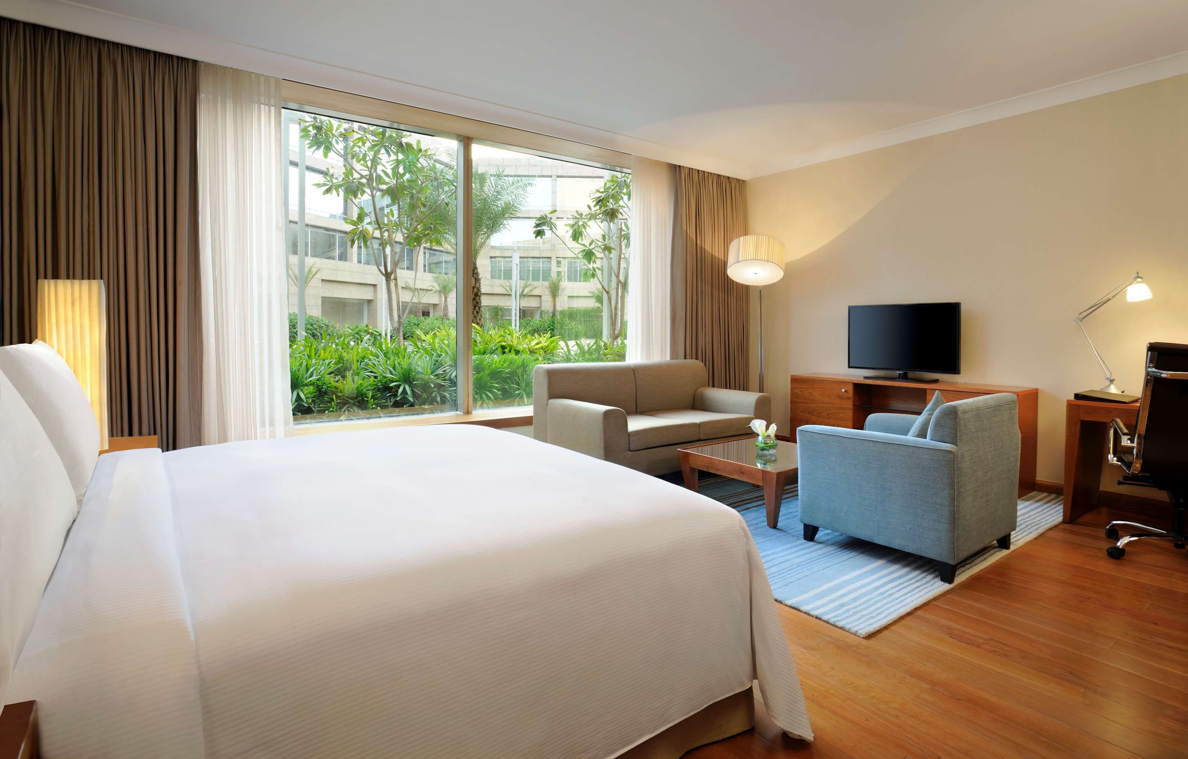 king deluxe pool or golf view with sofa cum bed, bathtub, 15% disc on f&b,spa | down duvets, minibar, in-room safe, individually decorated