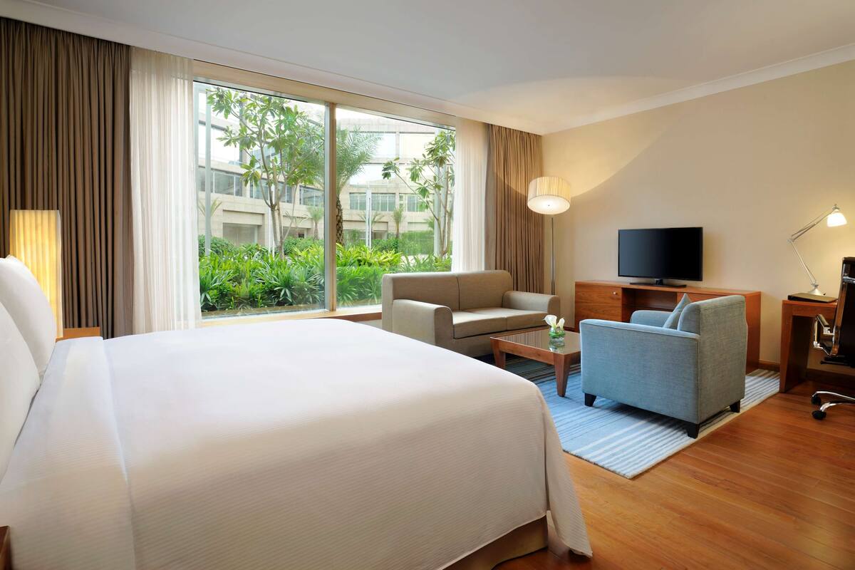 king deluxe pool or golf view with sofa cum bed, bathtub, 15% disc on f&b,spa | down duvets, minibar, in-room safe, individually decorated