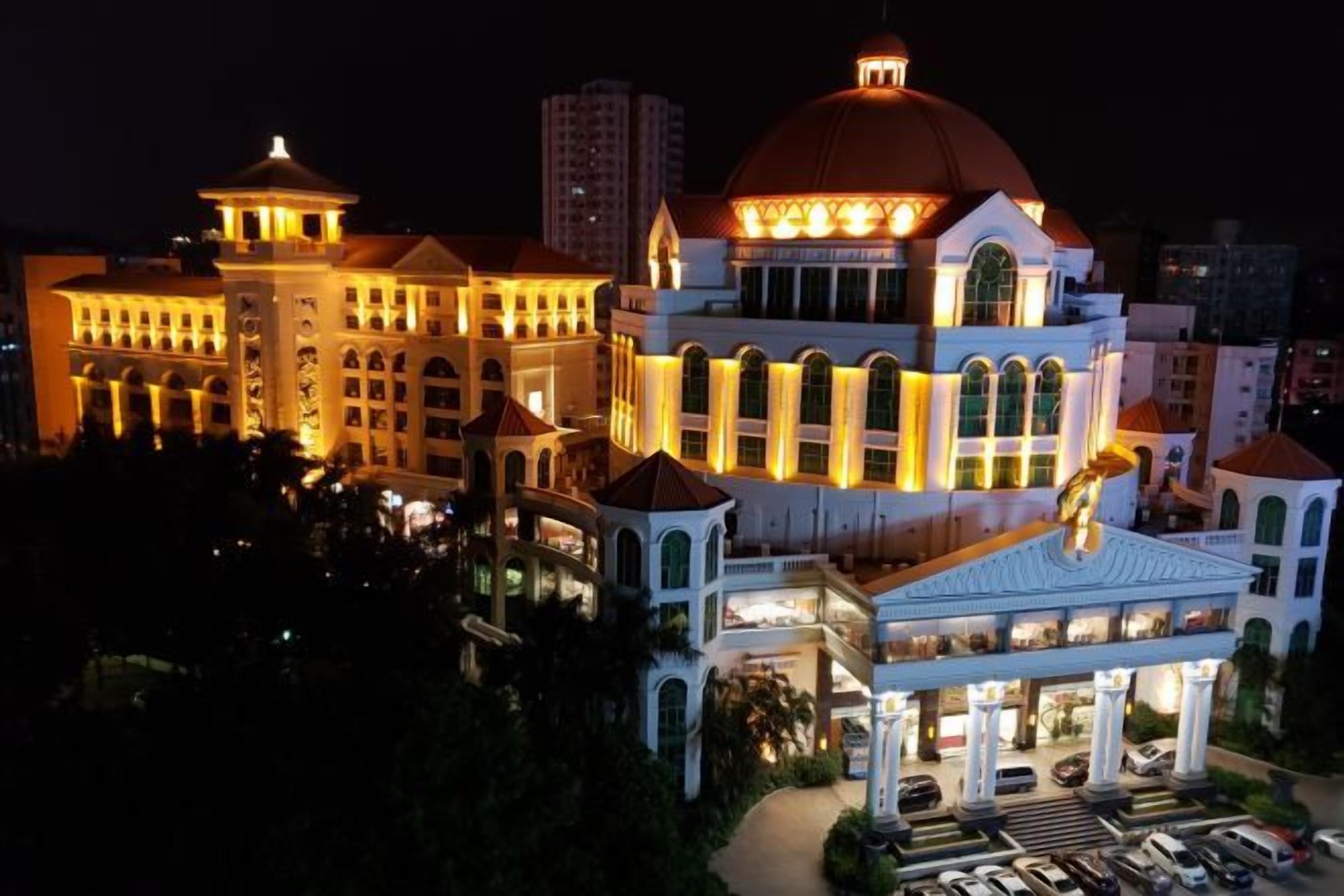 A large, multi-story building with a prominent dome and a series of balconies.