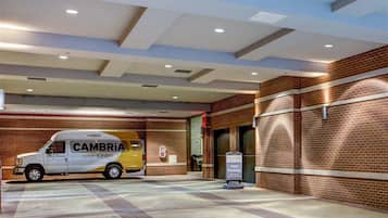 A parking area with a van labeled "Cambria Hotels & Suites" and a sign for "Cambria Valet Parking."