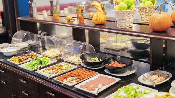 A buffet with various food items and decorative elements like pumpkins and cacti. - May Park Hotel (Izmir)