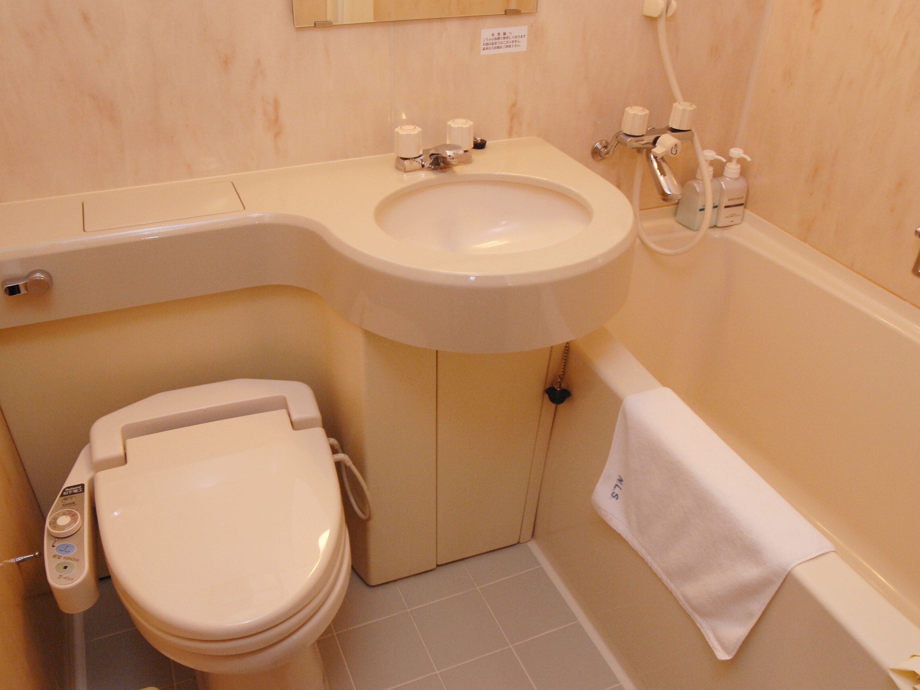 combined shower/bathtub, free toiletries, hair dryer, slippers