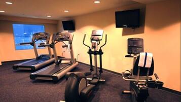 A gym with treadmills, an elliptical, and a weight machine.
