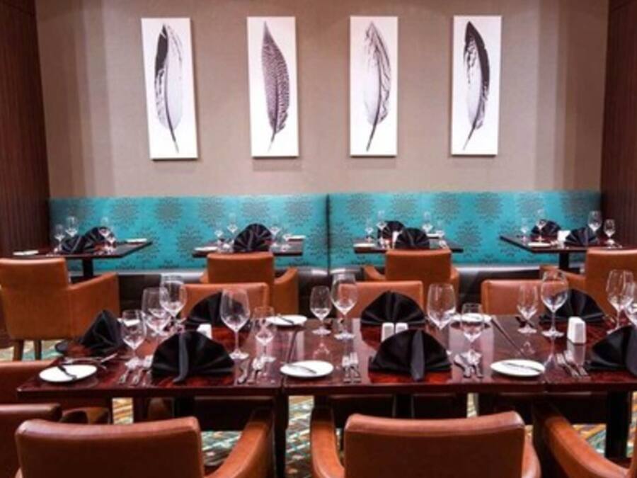 A conference room with tables set for dining, equipped with chairs and glassware.