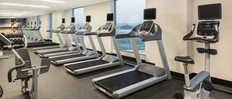 A gym with treadmills, ellipticals, and weight machines.