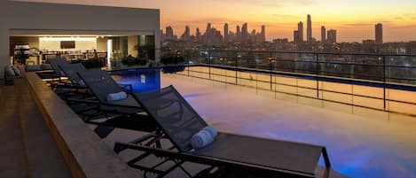 Outdoor pool, open 7:00 AM to 8:00 PM, pool umbrellas