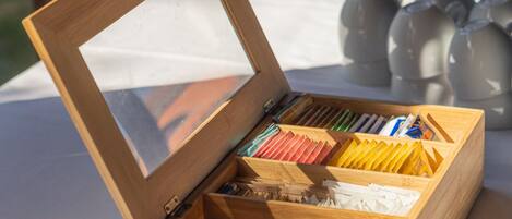 Una caja de madera con tapa transparente, que contiene varias tarjetas y papeles de colores, probablemente para registro de eventos o información.