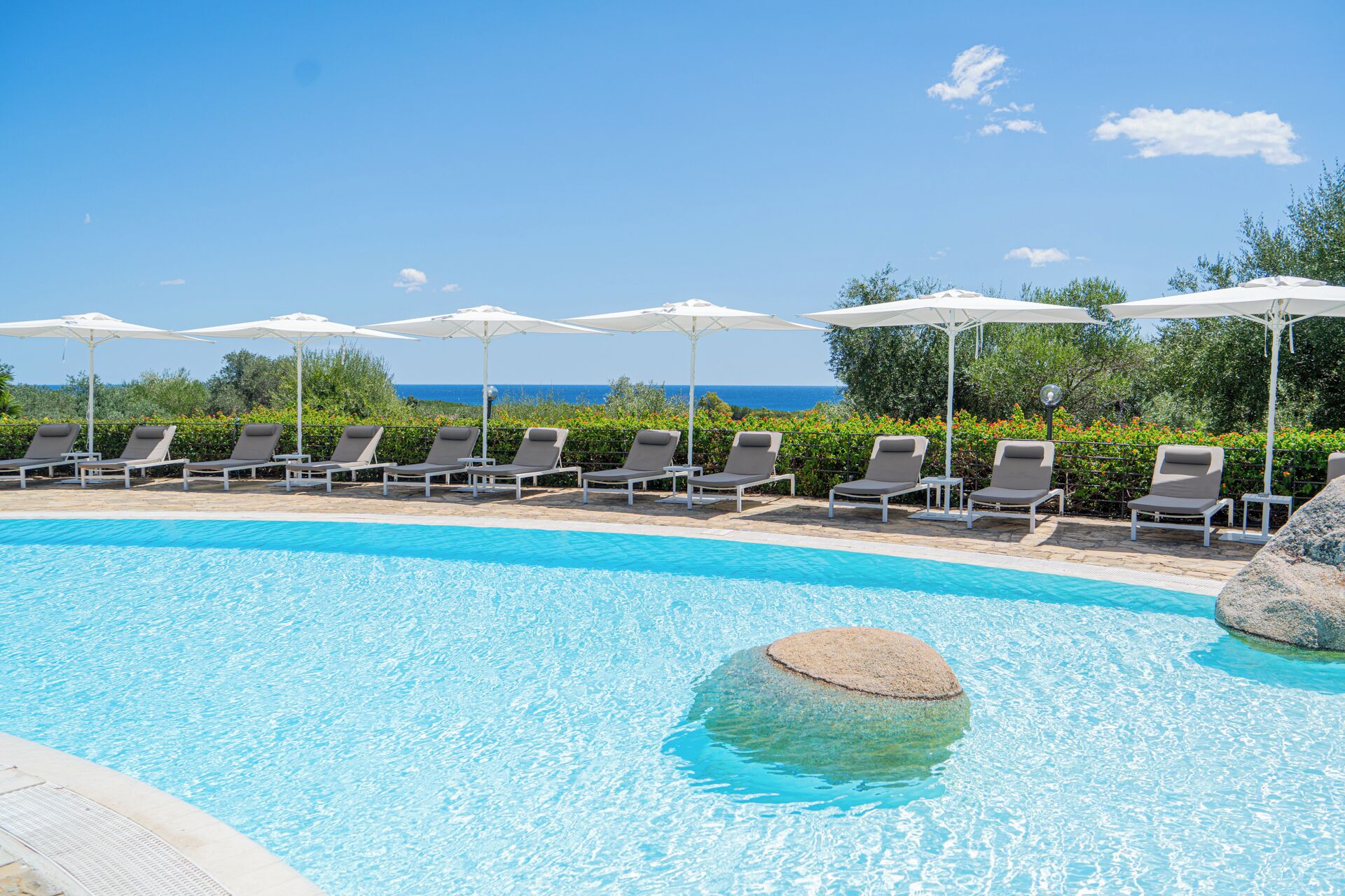 Seasonal outdoor pool, a waterfall pool, pool umbrellas, sun loungers