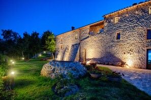 Traditional architecture meets serene surroundings in this charming stone building.