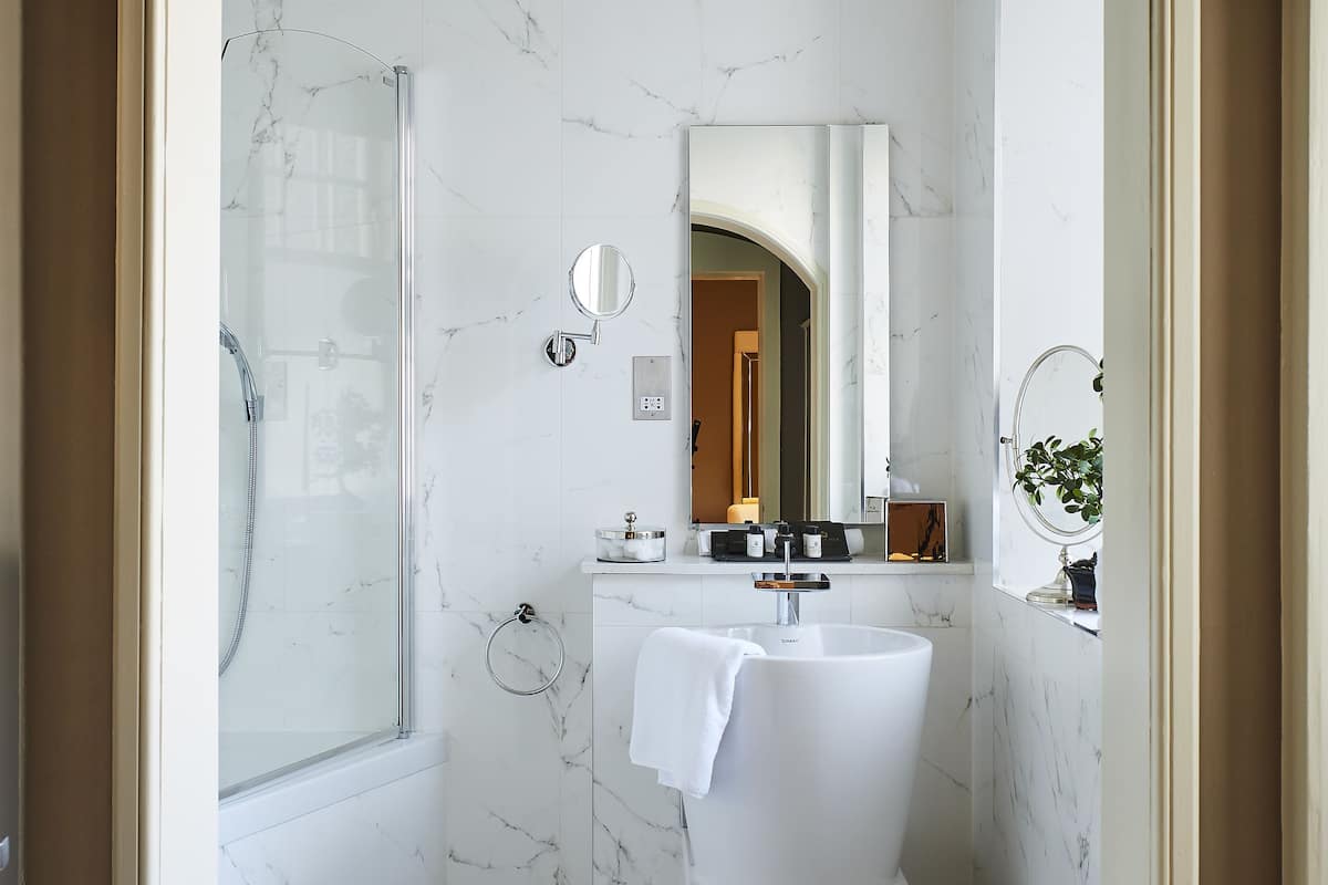 designer toiletries, hair dryer, bathrobes, slippers