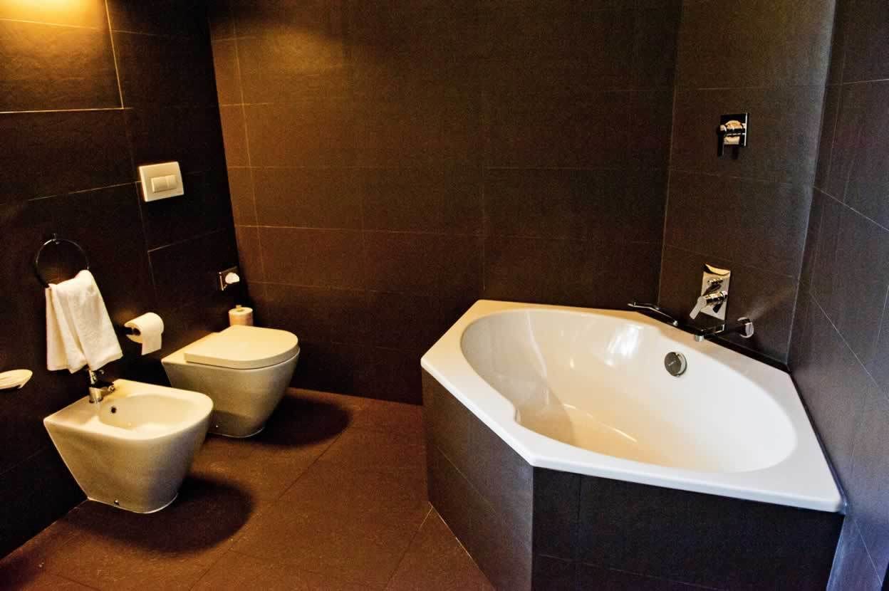 Un baño moderno con una bañera independiente, un bidé y un inodoro.