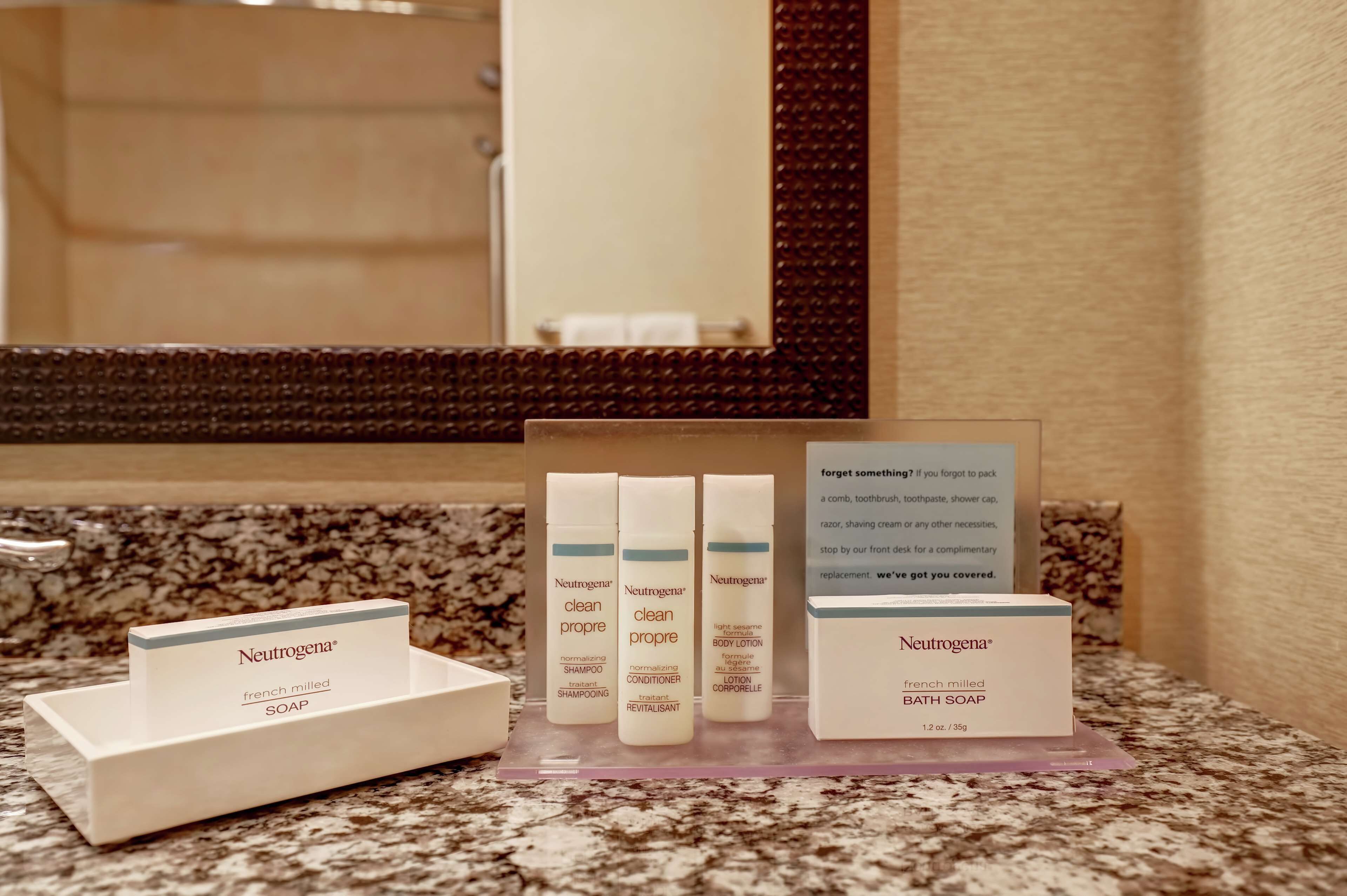 A bathroom counter with Neutrogena products including shampoo, conditioner, and body lotion.