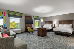 A hotel room with a bed, desk, chair, and a view of greenery outside. - Hampton Inn & Suites Adairsville-Calhoun Area (Adairsville)