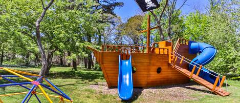 A pirate-themed playground with a slide and a climbing structure.