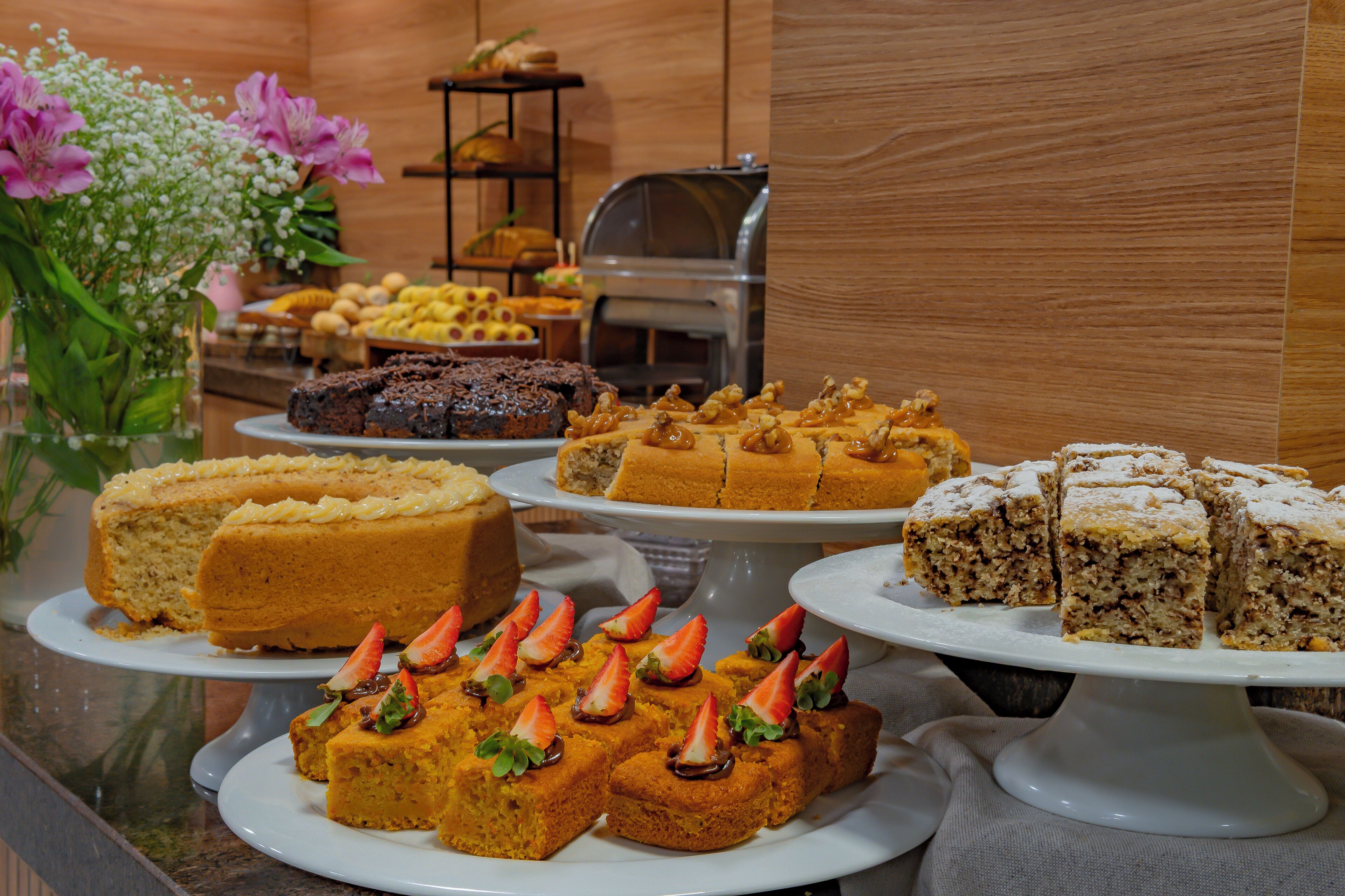 A buffet with various desserts including cakes and pastries.
