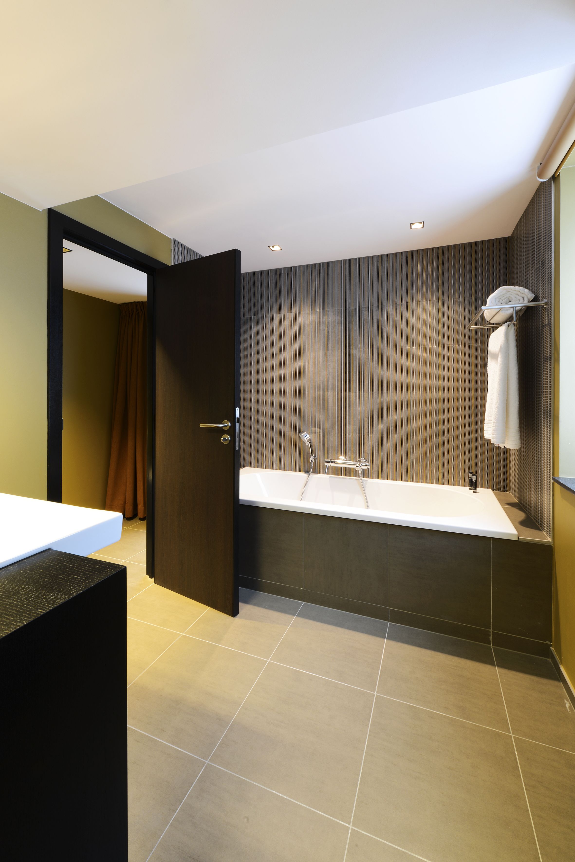 deluxe room (pool side) | bathroom | rainfall showerhead, designer toiletries, hair dryer, slippers