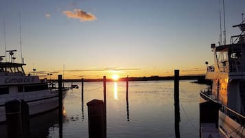 A boat docked at a pier during sunset.