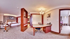 A hotel room with a bed, desk, chair, and a large mirror. - Huatian Chinagora Hotel (Alfortville)