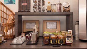 A buffet area with various food items and condiments. - Hôtel Eco (Banassac)