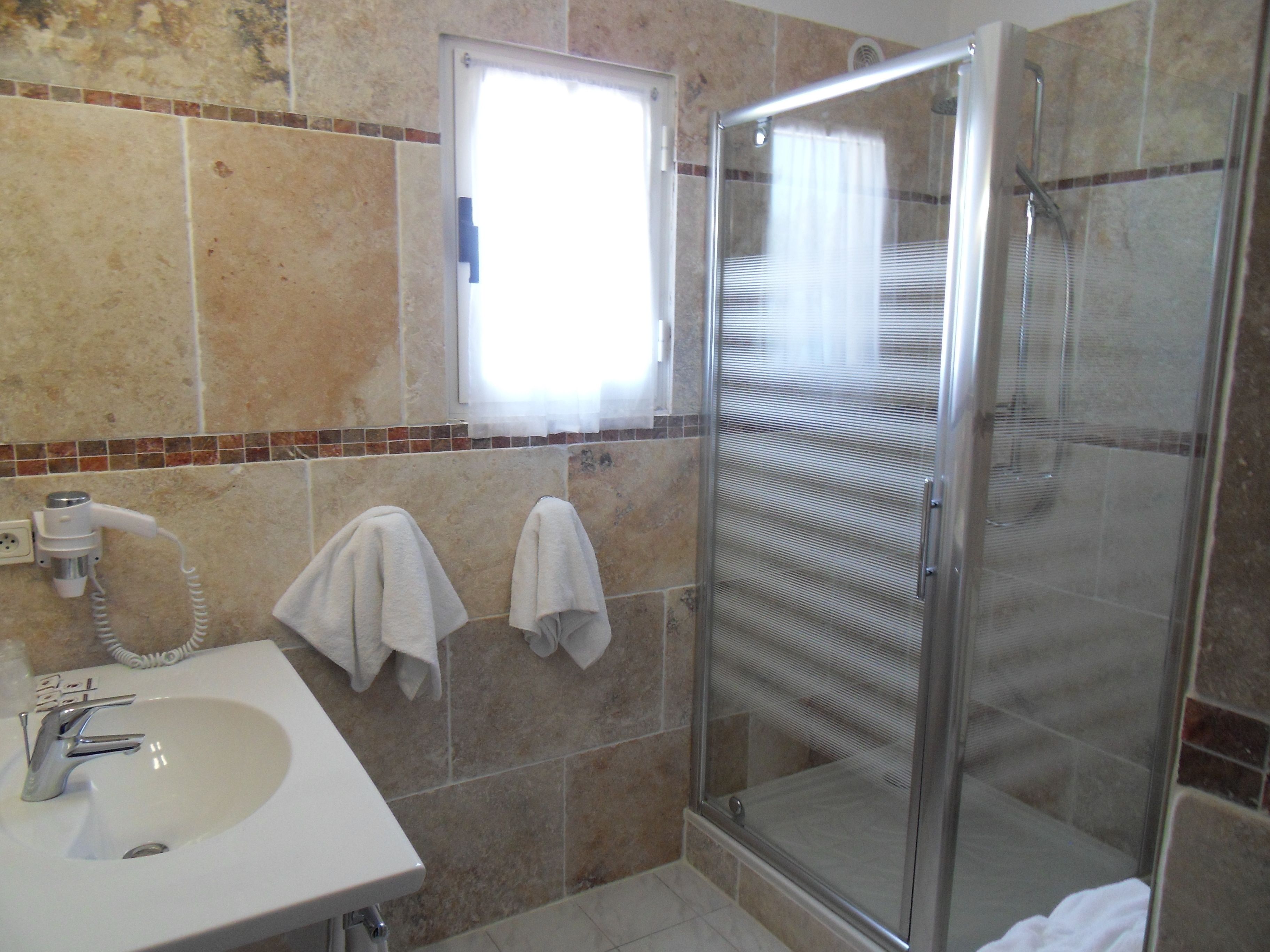 shower, hair dryer, slippers, towels