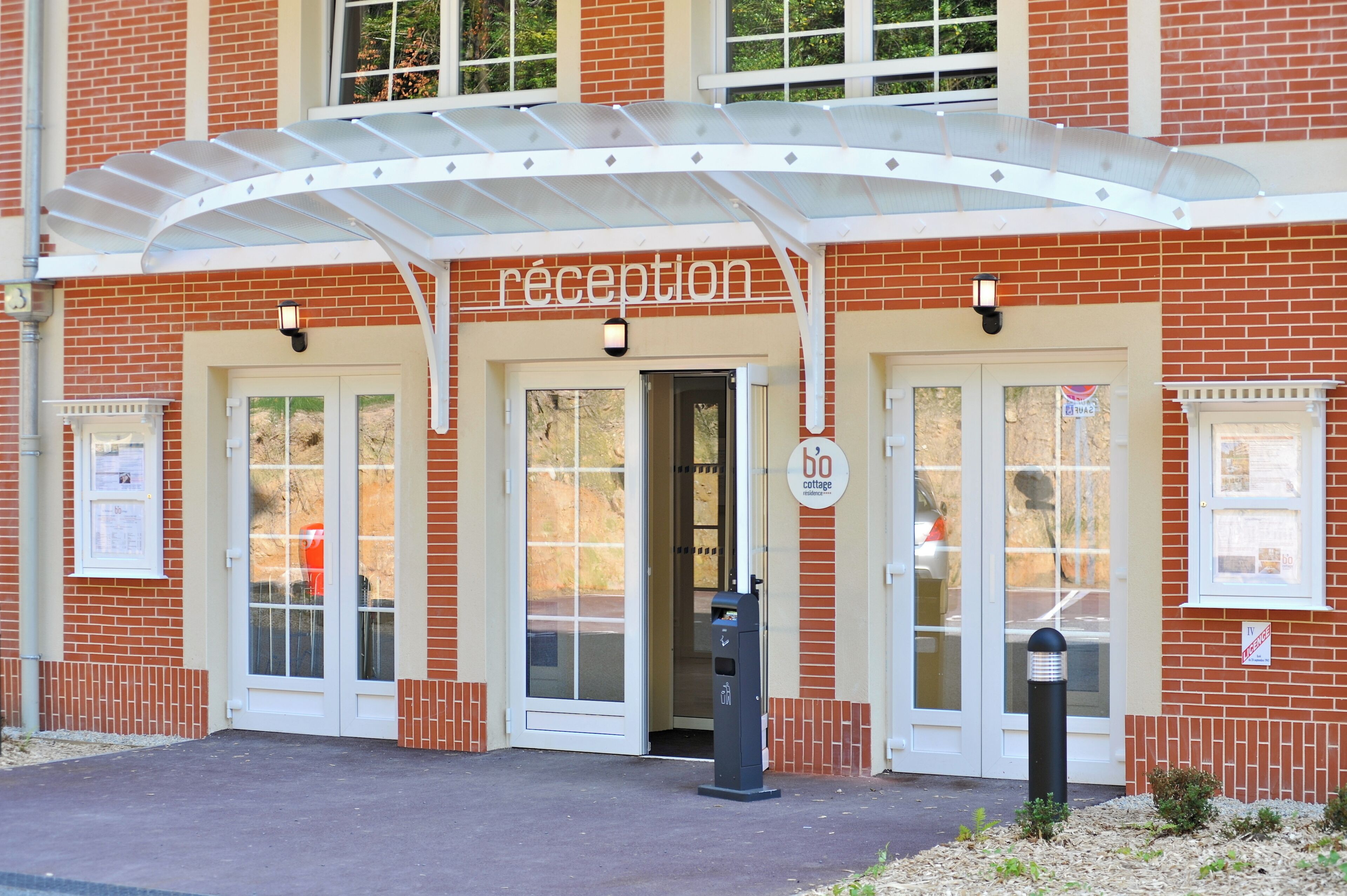 A reception area with a white canopy, a sign reading "reception," and a 60-minute cottage sign.