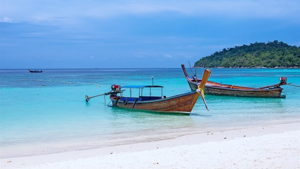 A beach with two boats anchored near the shore. - Gecko Lipe Resort (Koh Lipe)