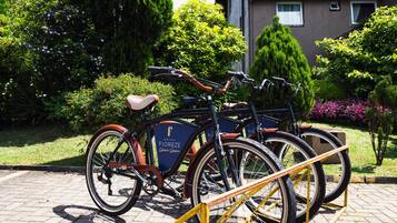 A bicycle rental station with bicycles parked in front of a building with a sign that reads "Hotel Fioreze."