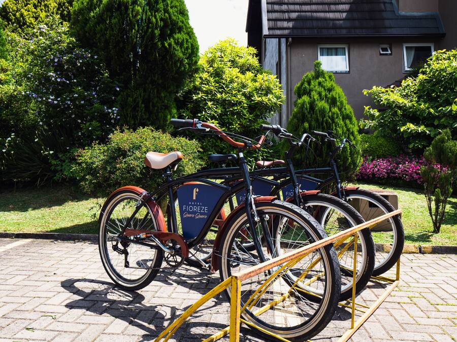 A bicycle rental station with bicycles parked in front of a building with a sign that reads "Hotel Fioreze."