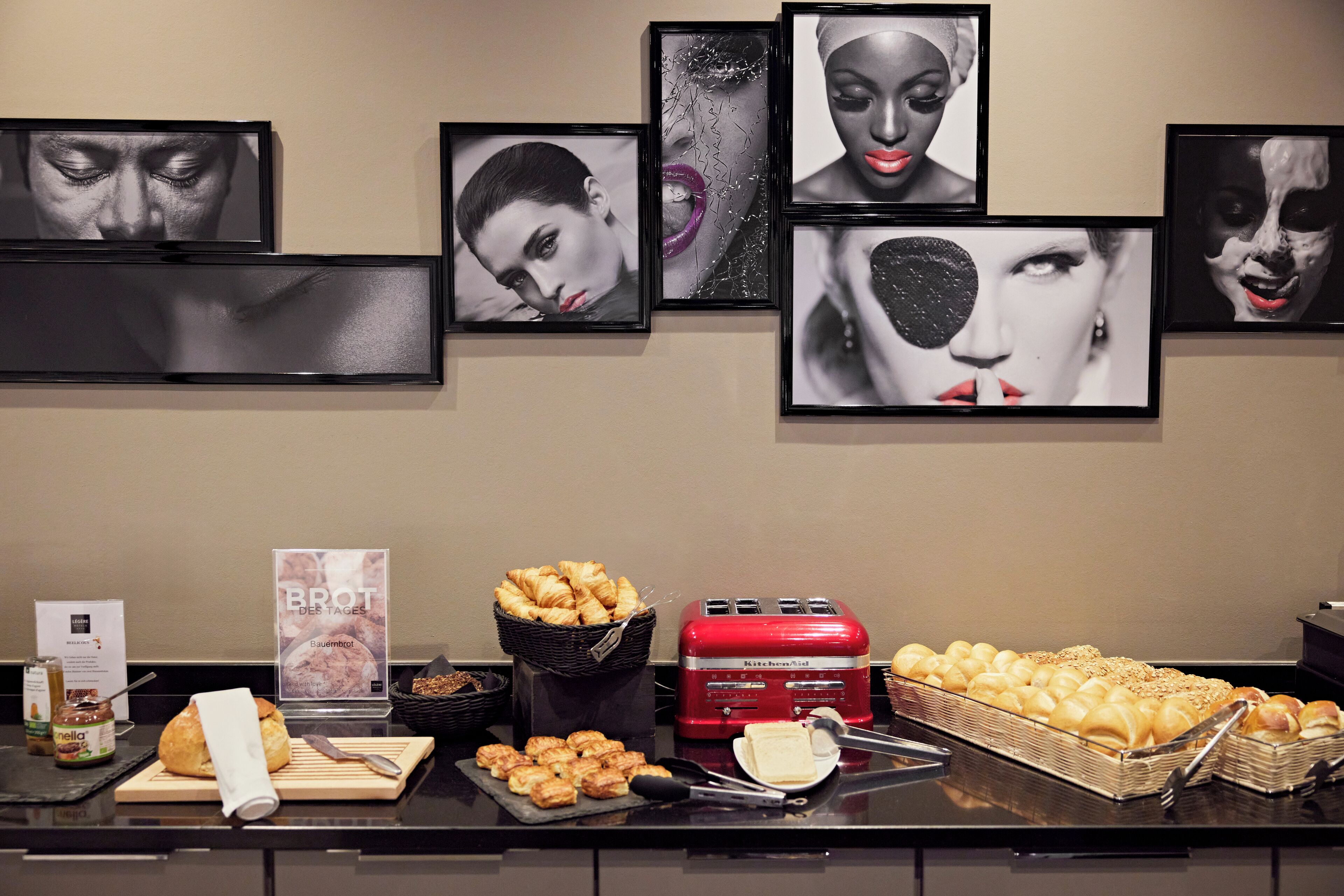 A breakfast buffet with pastries, bread, and spreads.