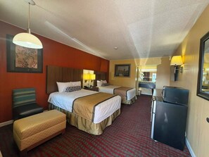 A hotel room with two beds, a desk, a refrigerator, and a dining area. - Duffys Motel Calhoun by Hotel O GA I-75 (Calhoun)