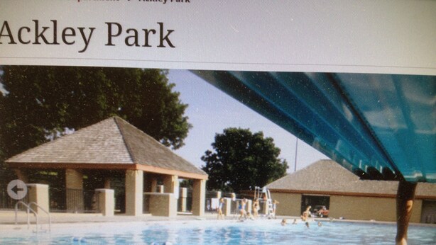 An indoor swimming pool with a covered area, a lifeguard tower, and a building labeled "Aquatic Center". - Sleep Inn & Suites Elk City Route 66 (Elk City)