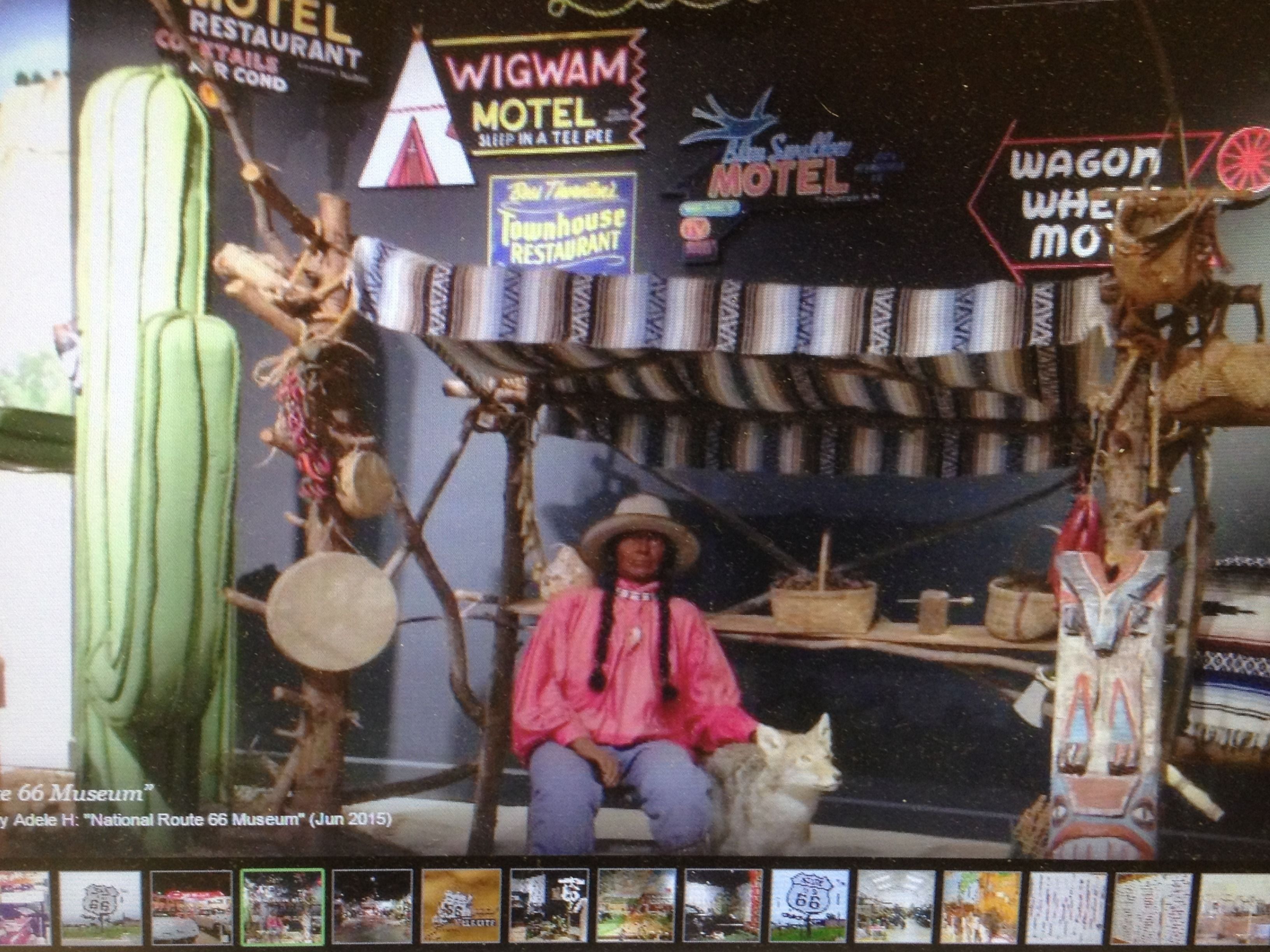A vintage-themed interior with a rustic wooden structure, a person in a pink shirt and hat, and a white cat.