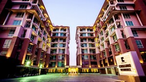 A modern hotel with a symmetrical facade, multiple balconies, and a central entrance. - Cinnamon Hotel Bangkok (Bangkok)