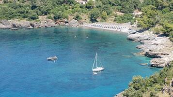 A coastal area with rocky terrain and clear blue water.