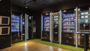 A modern interior with vending machines labeled 'PUSH Vision' and a wooden floor.