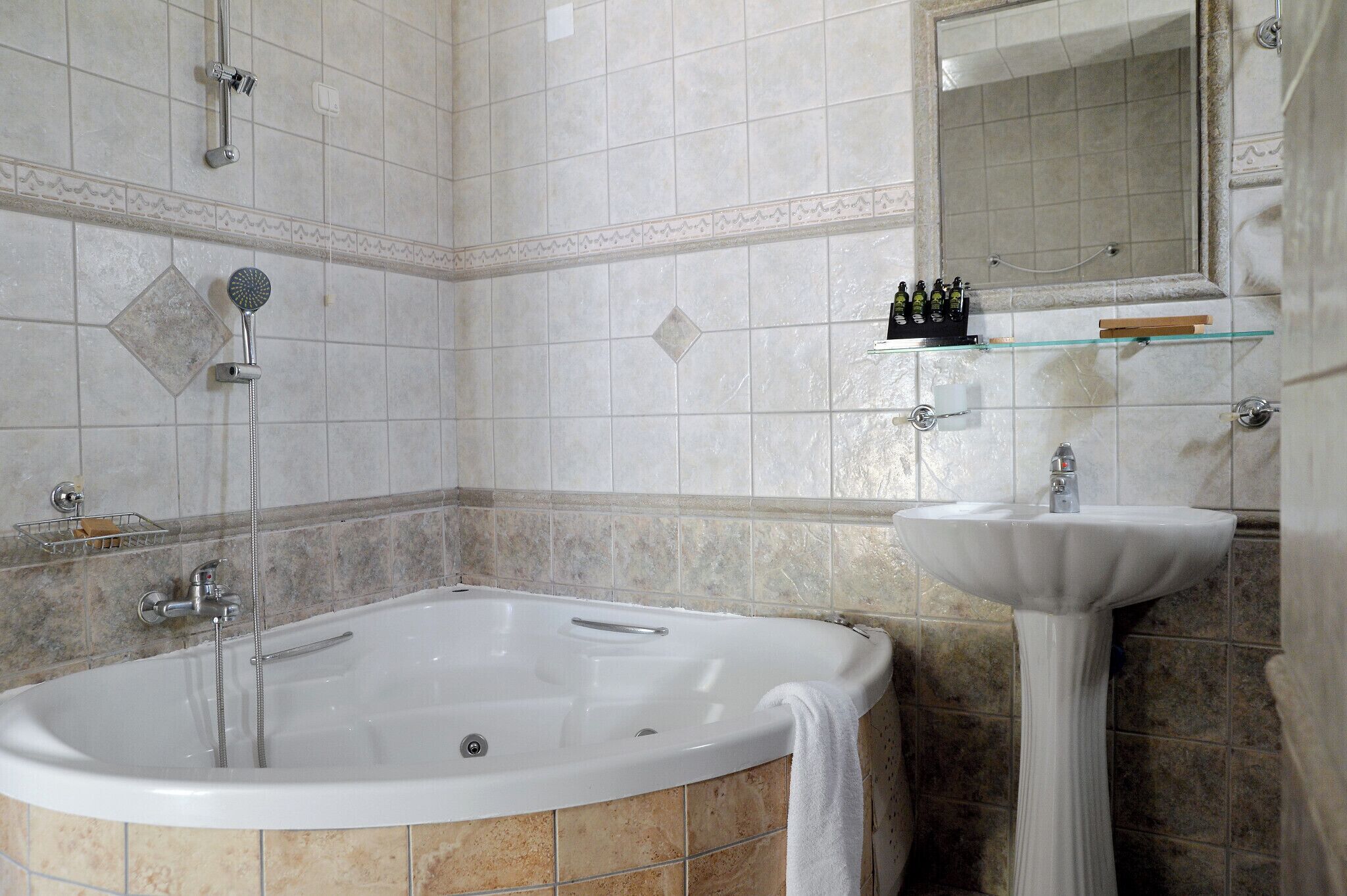 A bathroom with a bathtub, a sink, and a mirror.