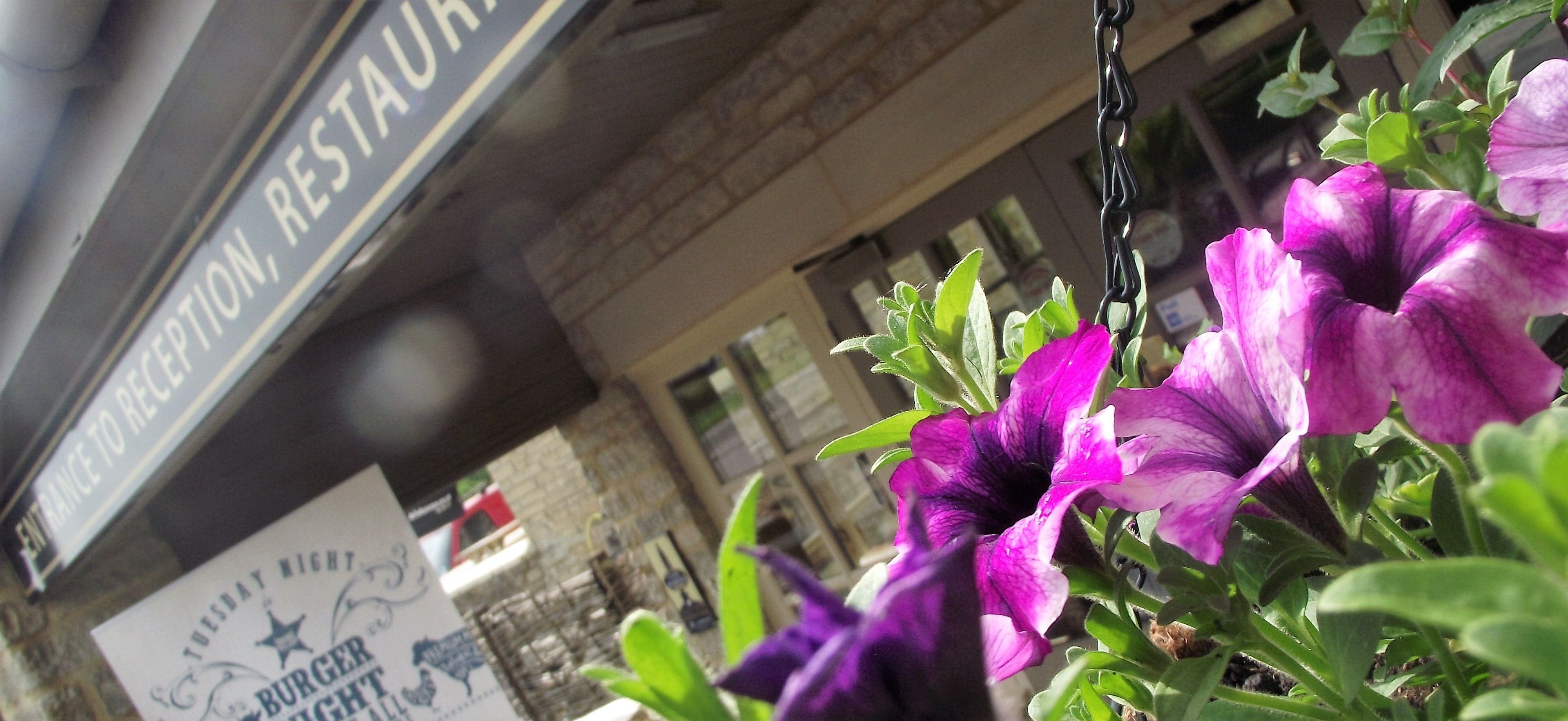 A restaurant entrance with a sign indicating it's open for Tuesday night.