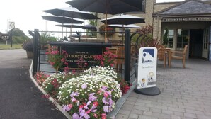 A sign for "Turdy's Castle" with a reception area and outdoor seating. - Sturdy's Castle Country Inn (Kidlington)